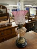 Lighting: 19th cent. Oil lamp gilt metal base, with pink tinted glass reservoir and graduated