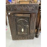 18th cent. Heavily carved chest corner cupboard with small inset lozenge mirror decoration. 27in.