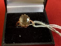 Jewellery: Yellow metal ring set with an oval cut citrine, tests as 9ct. gold. Weight 2·1g.