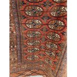 Carpets & Rugs: Late 19th early 20th cent. Bokhara rug. Red ground with eighteen guls and five