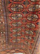 Carpets & Rugs: Late 19th early 20th cent. Bokhara rug. Red ground with eighteen guls and five