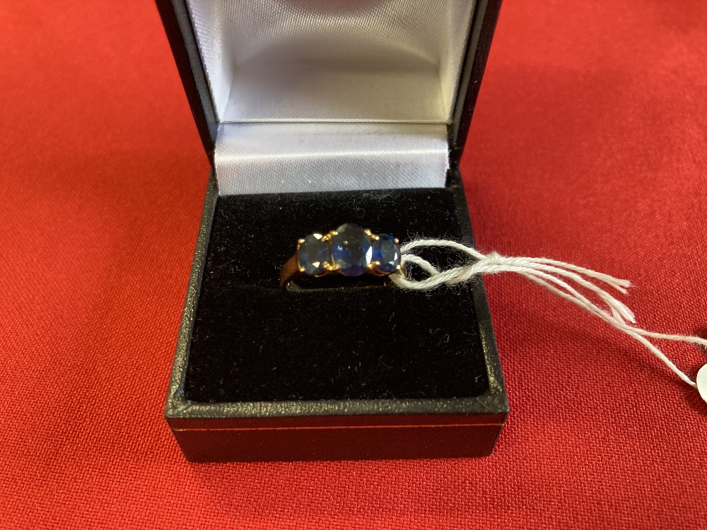 Jewellery: Yellow metal ring set with three oval cut sapphires. Estimated weight of (3) 1·75ct.