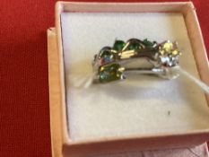 Jewellery: Three white metal rings, one set with emeralds, one set with a yellow sapphire and