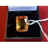 Jewellery: Yellow metal ring set with a rectangular cut citrine, tests as 9ct. gold. Weight 4·7g.