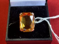 Jewellery: Yellow metal ring set with a rectangular cut citrine, tests as 9ct. gold. Weight 4·7g.