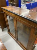 19th cent. Two door glazed bookcase with applied brass and inlaid decoration. 42in.