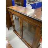 19th cent. Two door glazed bookcase with applied brass and inlaid decoration. 42in.