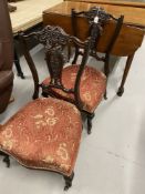 Late 19th/early 20th cent. pair of ebonised mahogany nursing chairs with pierced slat backs.