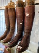 Equestrian: Two pairs of vintage red leather riding boots.