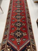 Carpets & Rugs: 19th cent. Kazak style runner with red ground and nine large guls with geometric