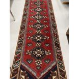 Carpets & Rugs: 19th cent. Kazak style runner with red ground and nine large guls with geometric