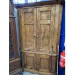 19th cent. Two section stripped pine corner cupboard. 81ins. x 51ins.