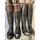Equestrian: Two pairs of vintage black leather riding boots, plus three polo mallets.