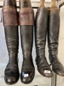 Equestrian: Two pairs of vintage black leather riding boots, plus three polo mallets.