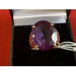 Jewellery: Yellow metal ring set with an oval cut synthetic alexandrite, tests as 9ct. gold.