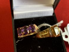 Jewellery: Two yellow metal rings, one set with three oval amethysts, and one with a citrine