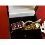 Jewellery: Two yellow metal rings, one set with three oval amethysts, and one with a citrine