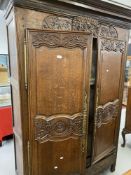 19th cent. French oak armoire with well carved floral & bouquet decoration, fitted ornate brass