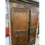 19th cent. French oak armoire with well carved floral & bouquet decoration, fitted ornate brass