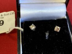 Diamond solitaire earrings each set in white gold, test 18ct. 0·40 the pair, weight inclusive 1g.