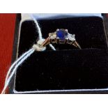 Hallmarked Jewellery: Ring, three stone claw set in white with a single oval cut sapphire, estimated