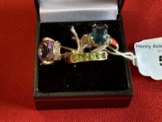 Jewellery: Yellow metal ring set with an oval cut amethyst with five 8 cut diamonds either side,