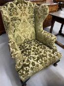 19th cent. Wingback armchair on club supports.