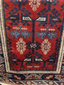 Carpets & Rugs: 19th cent. Shirvan carpet with a red central ground with geometric designs in