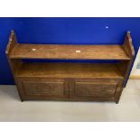 Edwardian oak hanging wall shelf with carved door panels.