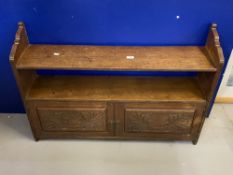 Edwardian oak hanging wall shelf with carved door panels.