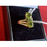 Hallmarked Jewellery: 9ct. Gold ring set with two large and three small peridot. Hallmarked