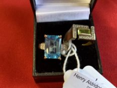 Hallmarked Jewellery: Two 9ct. gold rings, one set with a blue topaz, the other with a peridot and