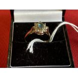 Hallmarked Jewellery: 9ct. Gold ring in the form of a cluster, set with a blue topaz, surrounded
