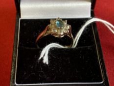 Hallmarked Jewellery: 9ct. Gold ring in the form of a cluster, set with a blue topaz, surrounded