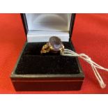 Jewellery: Yellow metal ring set with an oval amethyst, test as 9ct. Weight 3·2g.