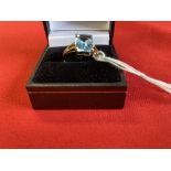 Jewellery: Yellow metal ring set with a rectangular cut blue topaz, estimated weight 2·25ct. with