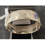 Hallmarked Silver: Hinged bangle with floral decoration hallmarked Birmingham. Weight 43·3g.