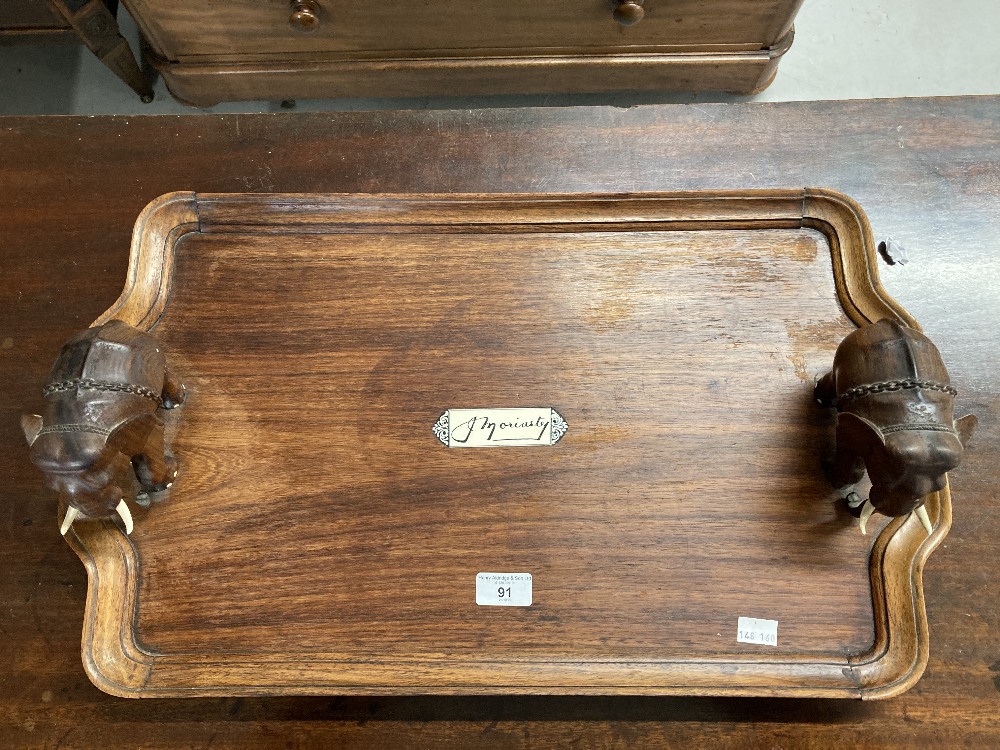 Late 19th/early 20th cent. Hardwood tray decorated with elephants. Inset ebony/ivory panel bearing