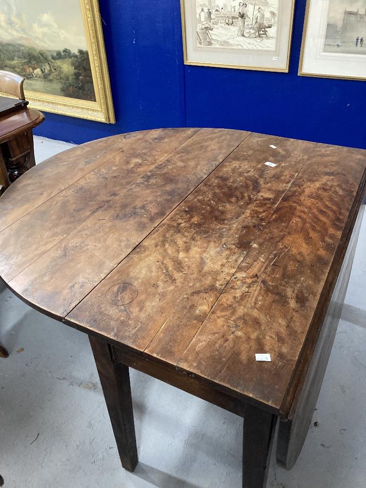 19th cent. Yew drop leaf dining table on tapered supports, eight plank. 75ins. x 45ins. x 28ins.