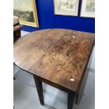 19th cent. Yew drop leaf dining table on tapered supports, eight plank. 75ins. x 45ins. x 28ins.