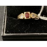 Gold Jewellery: Stamped 18ct. ring set with two old cut diamonds 0.20ct. total with a central