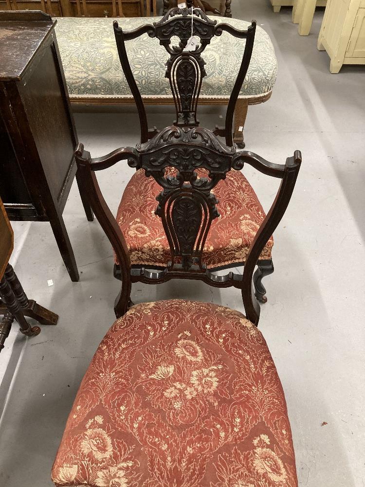 Late 19th/early 20th cent. pair of ebonised mahogany nursing chairs with pierced slat backs.