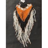 Costume Jewellery: 1st Nation American Navajo Jabot necklace of black, orange & white beads.