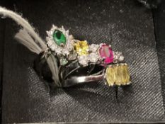 Costume Jewellery: White metal rings. All four set with coloured and white synthetic stones. Total