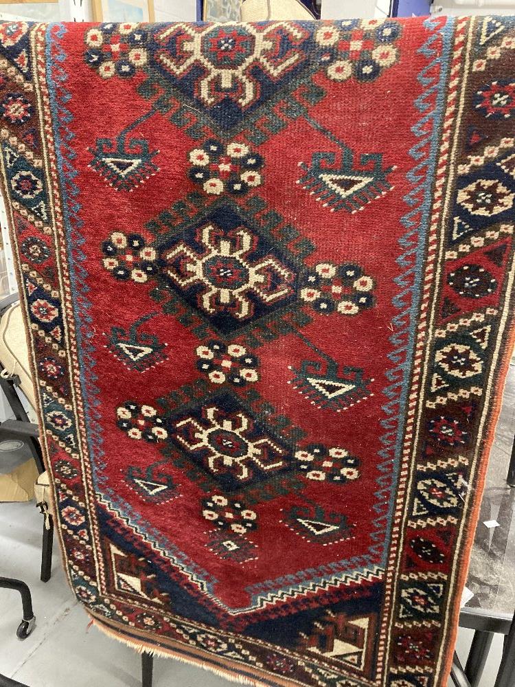 Carpets & Rugs: 19th cent. Kazak style runner with red ground and nine large guls with geometric