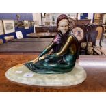 Art deco style figure of a seated lady in the manner of Menneville, cold painted resin on an onyx