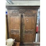 19th cent. French oak armoire with well carved floral & bouquet decoration, fitted ornate brass