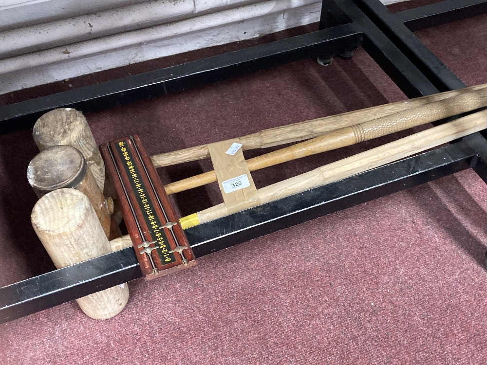 Three polo mallets and wooden snooker scoreboard.