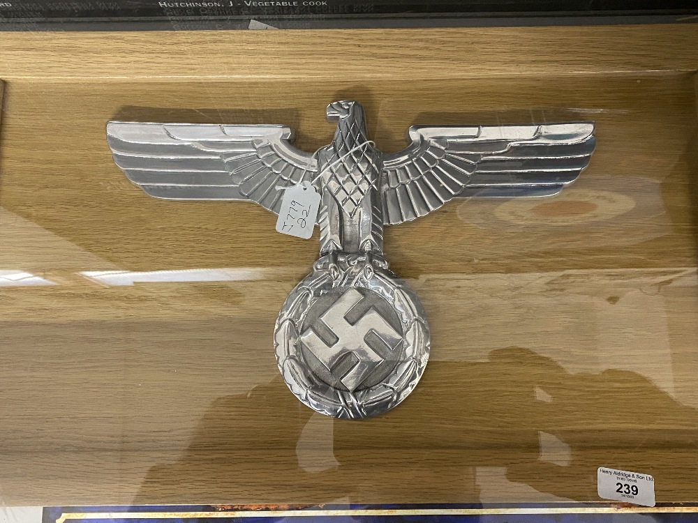 Militaria: Third Reich polished aluminium large eagle and swastika on an oak framed display board.