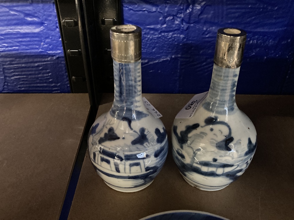 Chinese blue and white long necked mallet shaped vases with white metal collars, a pair. 6ins.